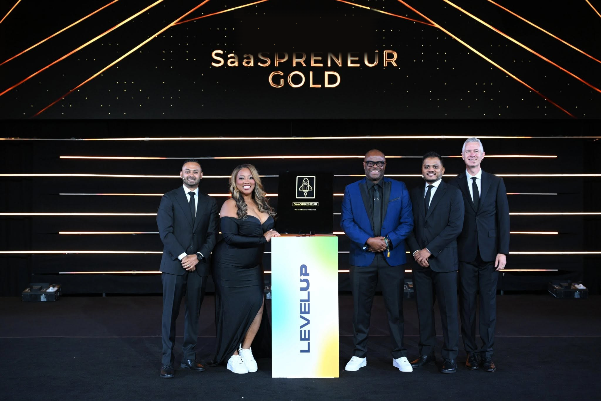 Lead Savage receiving a Gold SaaS Award on stage